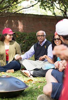 Social Work students and instructor have class outside.
