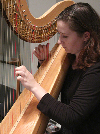 Music student plays the harp.