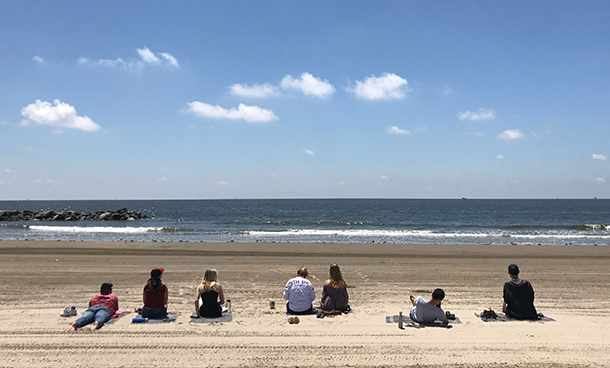Students study at the beach.