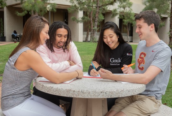 Law school students talk outside building.