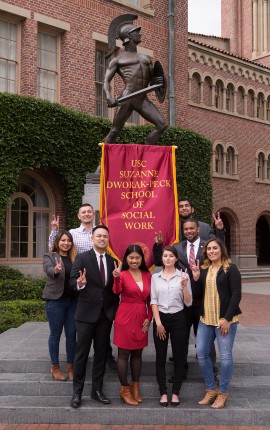 MSW graduates celebrate in front of Tommy Trojan.