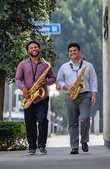 USC Thornton jazz studies students Jordan DeTiege & Ennis Harris walk through downtown Los Angeles.